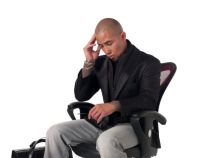 photo-24723911-tensed-businessman-sitting-on-chair.