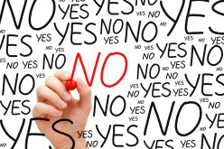 Hand writing No with red marker on transparent wipe board.