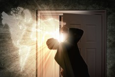 Image of young businessman opening door with lights