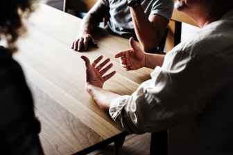 people sitting in front of wooden table